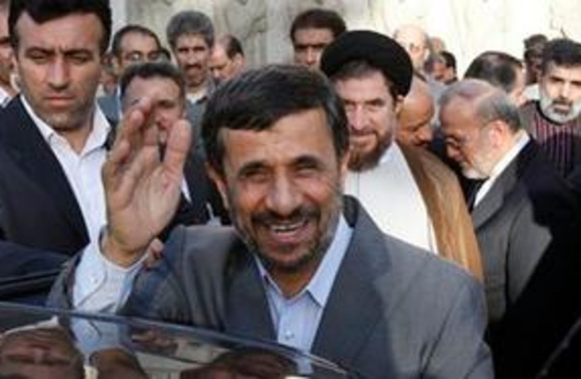 Ahmadinejad smiling, waving 311 (photo credit: AP Photo/Vahid Salemi)