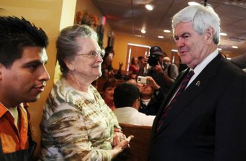 Republican Newt Gingrich greets voters in Florida 390 (R) (photo credit: REUTERS/Shannon Stapleton)