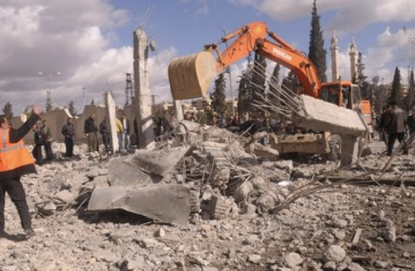 Excavator at site of Aleppo blasts 390 (photo credit: REUTERS/Stringer)