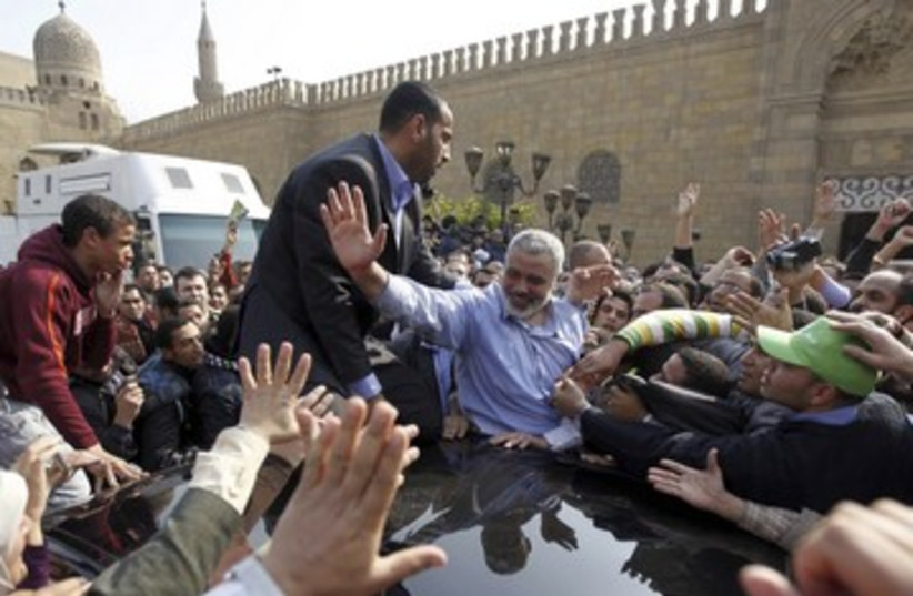 Haniyeh waves to supporters after Friday speech in Cairo 390 (photo credit: REUTERS/Mohamed Abd El Ghany)