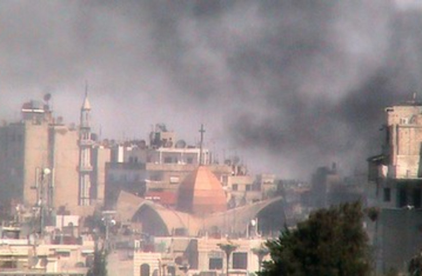 Smoke rises from the Bab Sabaa neighbourhood of Homs 390 (R) (photo credit: REUTERS/Shaam News Network/Handout)