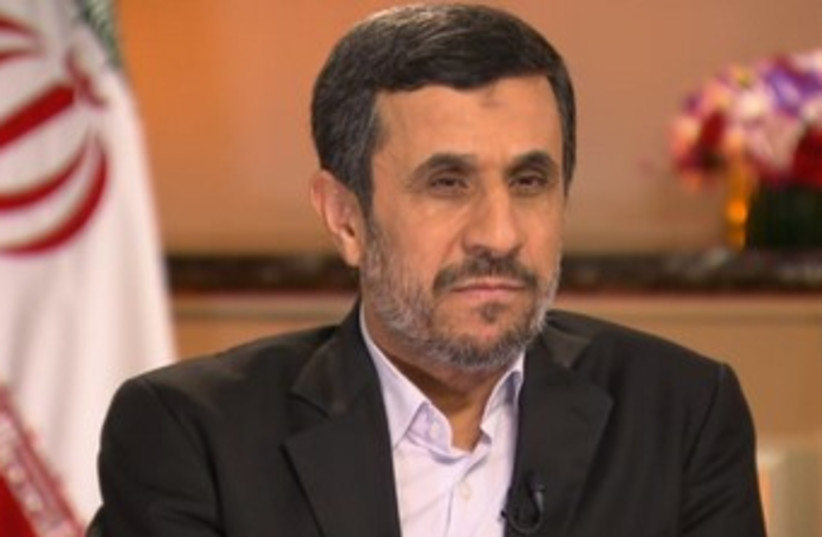 Ahmadinepoopoo with flag behind him 370 (photo credit: Screenshot)