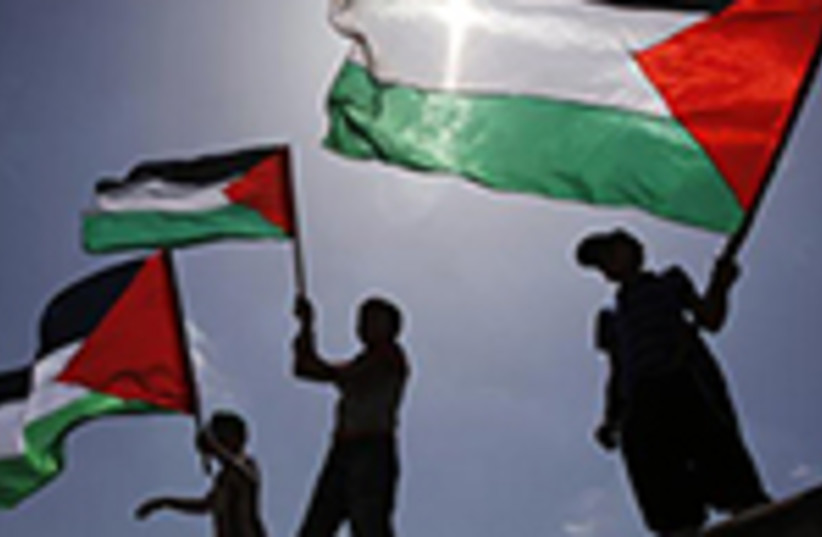 Palestinians wave PLO flags (photo credit: REUTERS)