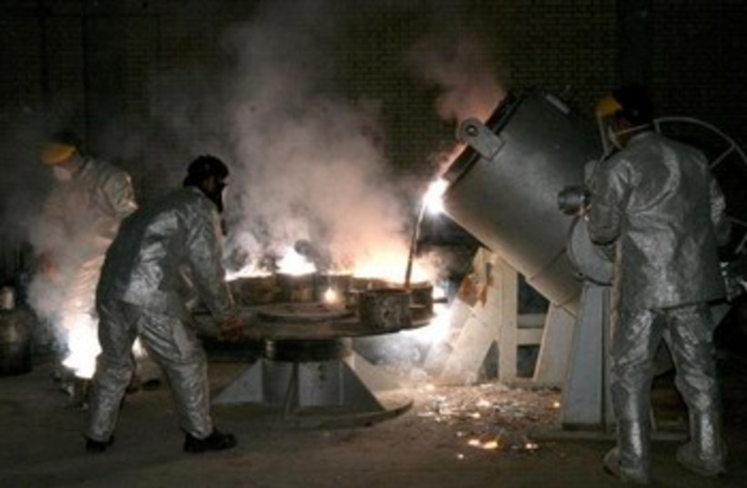 Iranian technicians work at a uranium processing site in Isfahan. (credit: REUTERS)
