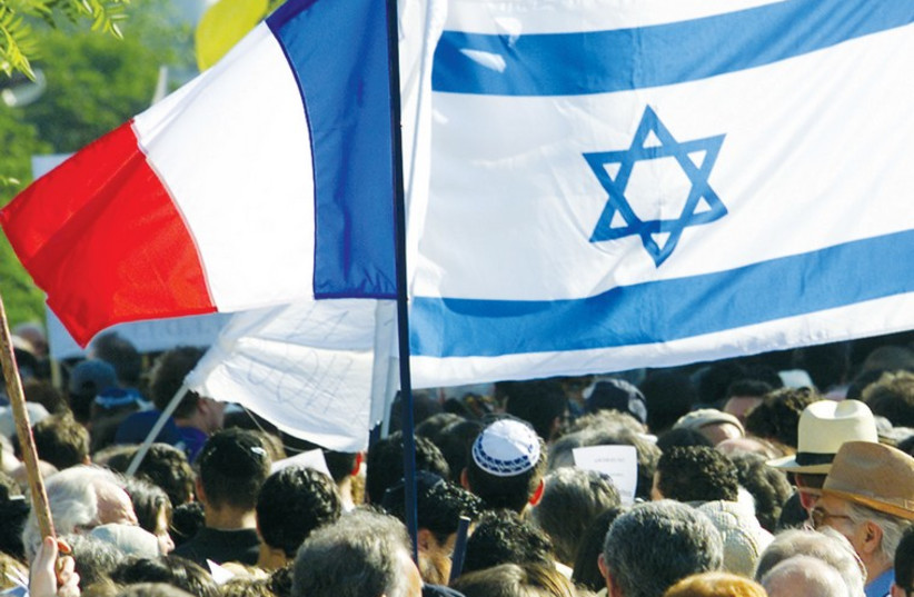 A French and Israeli flag are seen during a 2001 demonstration in Paris. (photo credit: REUTERS)