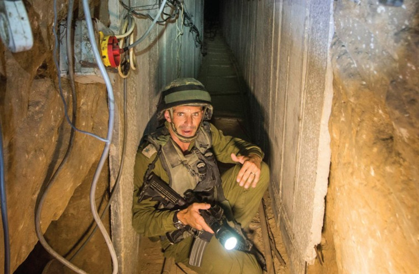 AN ISRAELI army officer explains to journalists how Hamas built tunnels to attack the country. (photo credit: REUTERS)