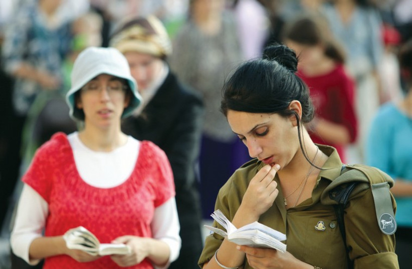 A religious woman and a female soldier pray at the Western Wall. (photo credit: MARC ISRAEL SELLEM/THE JERUSALEM POST)