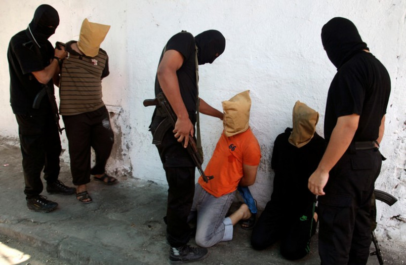 Hamas operatives prepare to execute alleged collaborators in the Gaza Strip. (photo credit: REUTERS)