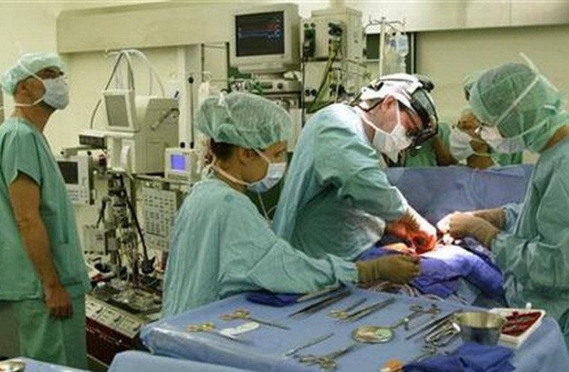 Doctors perform surgery [illustrative]. (credit: REUTERS)