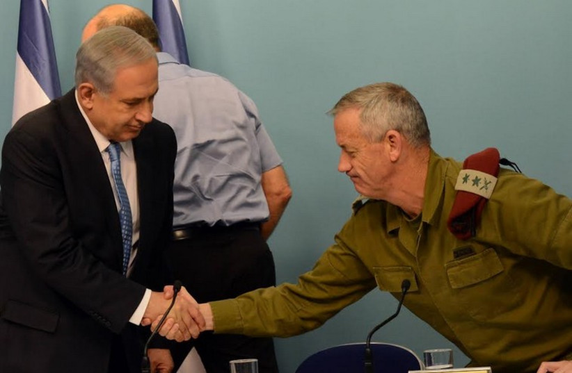 Prime Minister Benjamin Netanyahu (L) shakes hands with then-IDF chief of staff Benny Gantz during the 2014 Gaza conflict. (photo credit: HAIM ZACH/GPO)