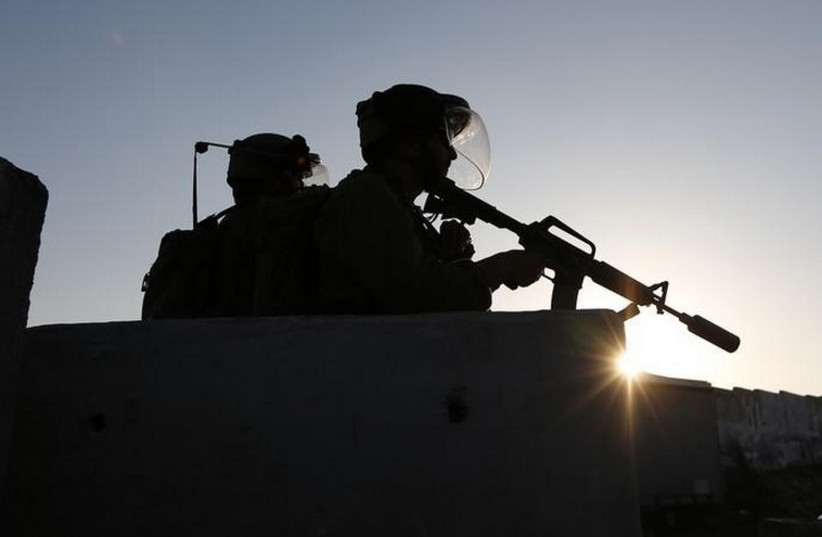 Soldiers keep guard at checkpoint near Qalandia  (photo credit: REUTERS)