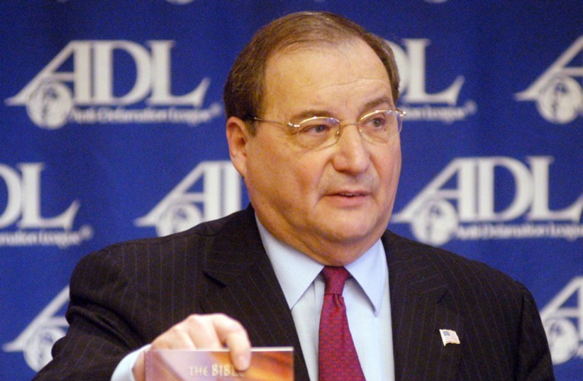 Abraham H. Foxman, National Director of the Anti-Defamation League, shows the book "The Bible, the Jews, and the Death of Jesus"  (photo credit: REUTERS)