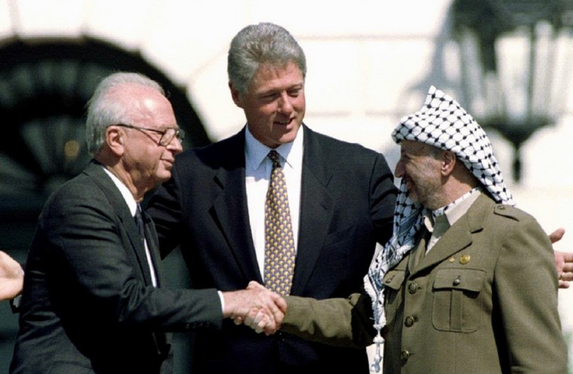 Slain Israeli Prime Minister Rabin with former US President Bill Clinton and former PLO President Yasser Arafat after signing the Oslo Accords at the White House on September 13, 1993.  (credit: REUTERS)
