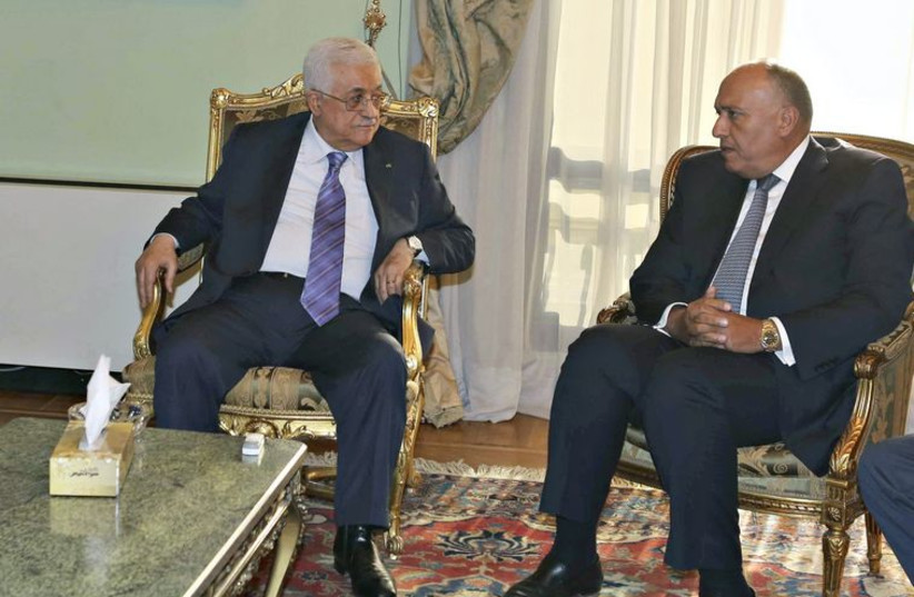 Palestinian Authority President Mahmoud Abbas meets Egyptian Foreign Minister Sameh Shukri and Arab League Secretary General Nabil al-Araby ahead of Gaza aid conference. (photo credit: REUTERS)