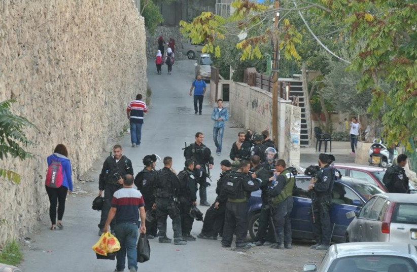Police gather in the capital’s Isawiya neighborhood to prevent riots in the flash-point area. (photo credit: SETH J. FRANTZMAN)