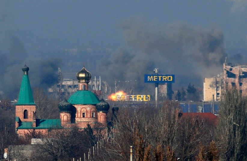 Smoke rises above an old terminal (L) and an administrative building of the Sergey Prokofiev International Airport after the recent shelling during fighting between pro-Russian separatists and Ukrainian government forces in Donetsk, eastern Ukraine, November 9, 2014. (photo credit: REUTERS)