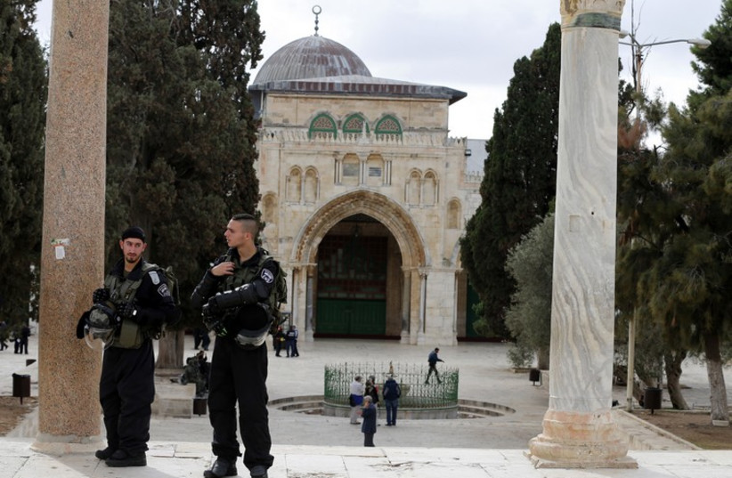Israeli police officers stand guard on the Temple Mount  compound in Jerusalem's Old City (photo credit: REUTERS)
