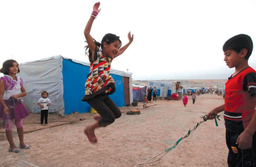 Syrian refugee children play at the Domiz refugee camp in the northern Iraqi- Kurdistan province of Dohuk, on September 3, 2013. (photo credit: REUTERS)