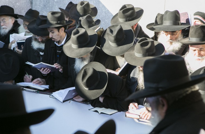 Rabbis pray at the gravesite of the Lubavitcher Rebbe, Rabbi Menachem M. Schneerson (photo credit: ADAM BEN COHEN / CHABAD.ORG)