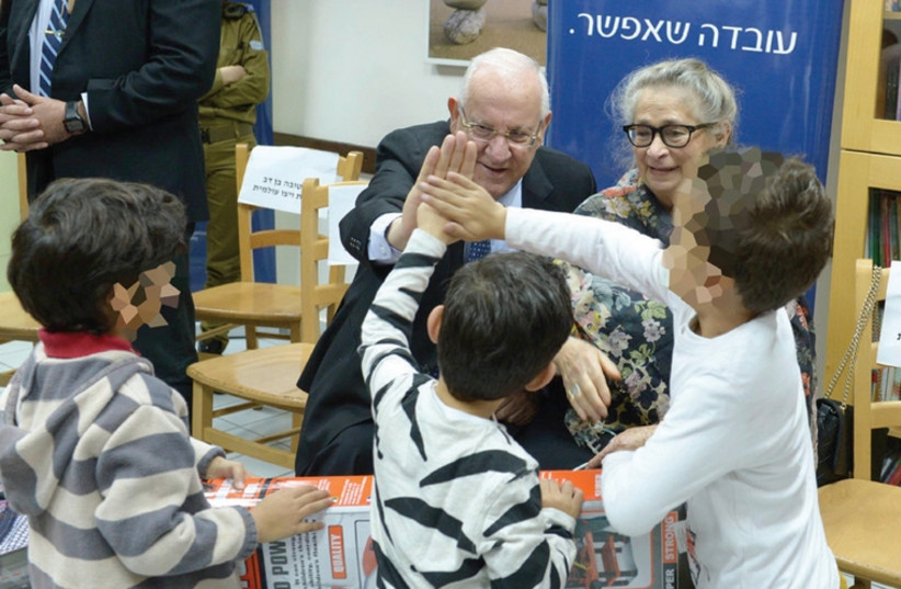 Reuven and Nechama Rivlin with children at the WIZO shelter. (photo credit: Mark Neiman/GPO)