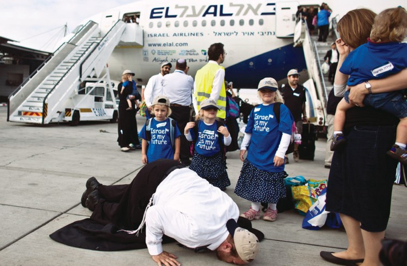 A new immigrant at Ben-Gurion airport kisses the tarmac as he makes aliya (photo credit: REUTERS)
