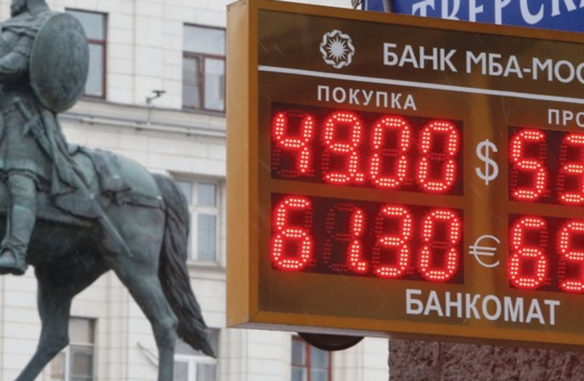 A BOARD showing currency exchange rates in Moscow on Monday, when oil prices fell to their lowest in five years. Russia’s ruble dropped more than 4 percent against the dollar while Malaysia’s ringgit, also oil-dependent, was on course for its biggest two-day fall since the 1997-8 Asian financial cri (credit: REUTERS)
