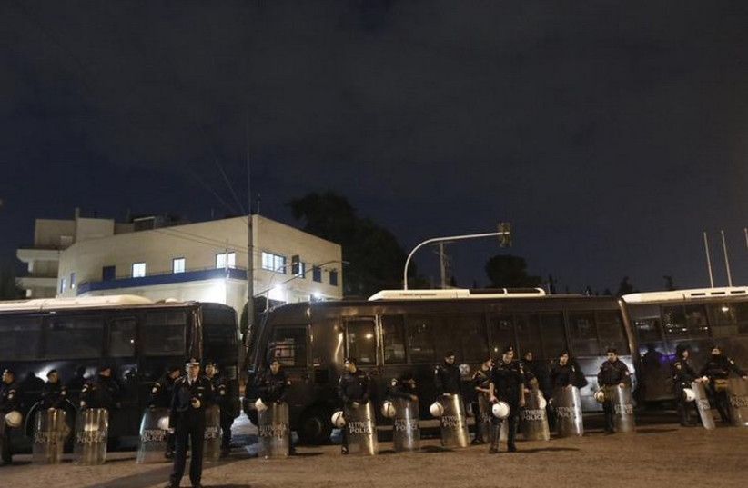 Riot police stand guard outside the Israeli embassy in Athens in 2012 (photo credit: REUTERS)
