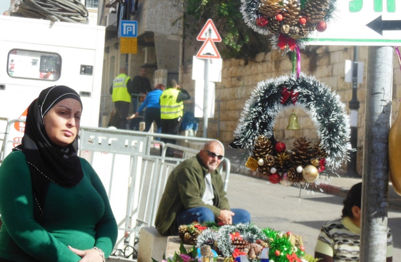 An Arab woman sells holiday decorations during the Festival of Festivals (photo credit: ARIEL COHEN)