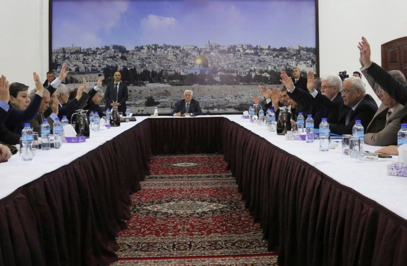 Palestinian Authority President Mahmoud Abbas (C) meets with the Palestinian leadership to sign agreements in Ramallah (photo credit: REUTERS)