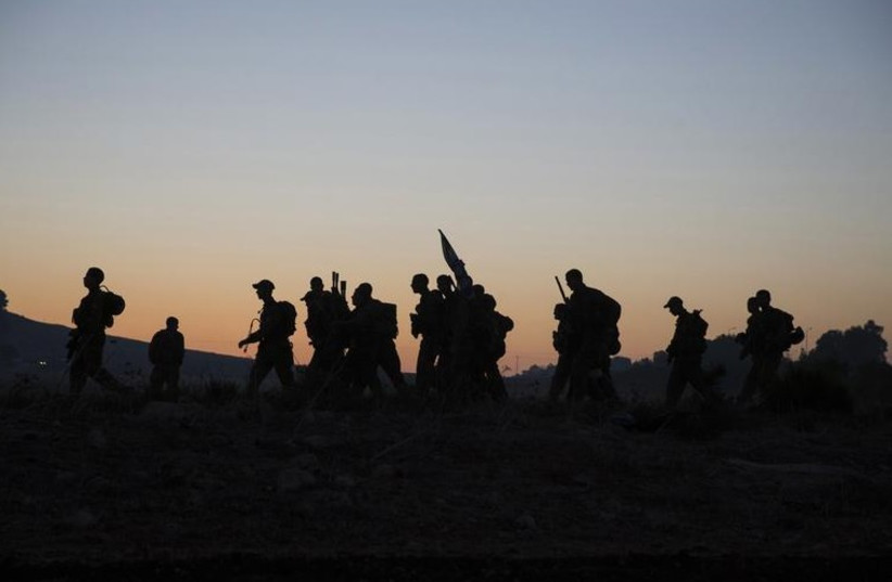 IDF combat soldiers complete a long march as part of their advanced training (photo credit: REUTERS)