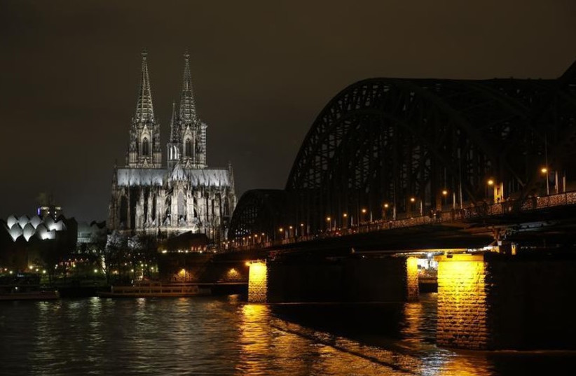 Picture shows the famous Cologne Cathedral before its illumination is switched off in a protest against a march by the growing grass-roots anti-Muslim movement through the western German city of Cologne (photo credit: REUTERS)