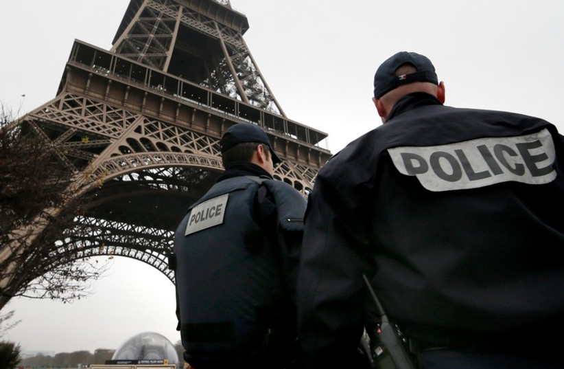 French police patrol near the Eiffel Tower as security in Paris is bolstered after a shooting killed 12 (photo credit: REUTERS)