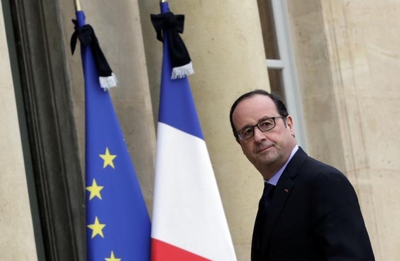French President Francois Hollande enters the Elysee Palace in Paris (photo credit: REUTERS)