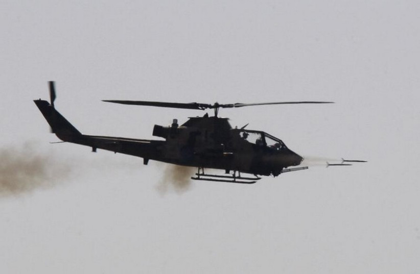 A combat Cobra helicopter fires during the EFES-2010 military exercise in Izmir  (photo credit: REUTERS)
