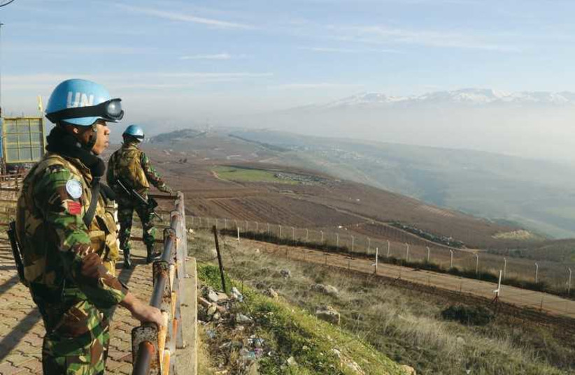 Indonesian soldiers, part of the United Nations Interim Force in Lebanon, look out over the Lebanese-Israeli border on January 19. (photo credit: REUTERS)