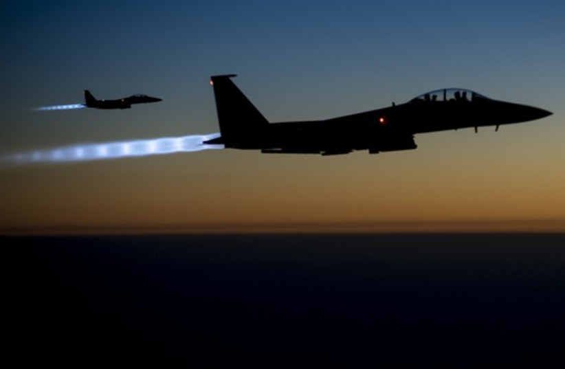 A pair of US Air Force F-15E Strike Eagles fly over northern Iraq after conducting airstrikes in Syria (credit: REUTERS)