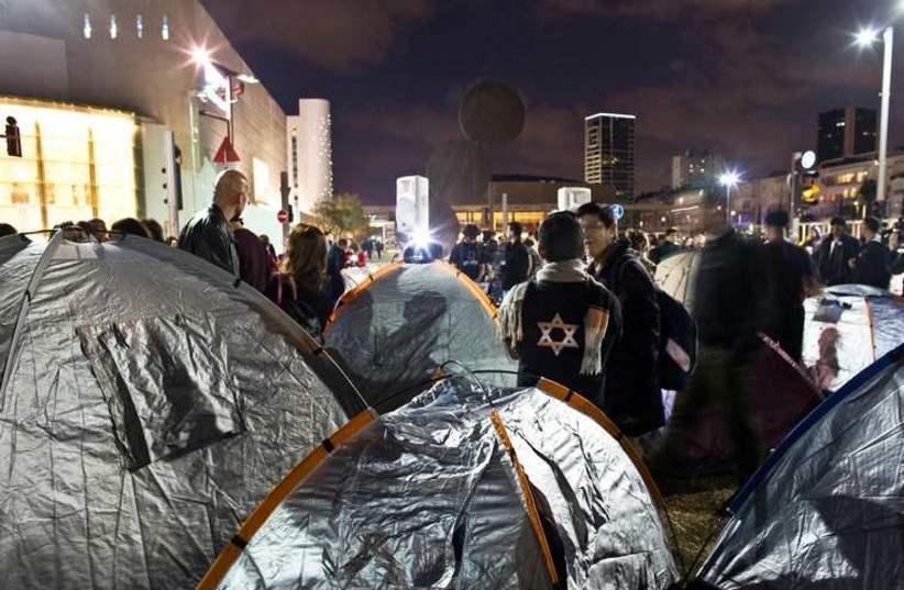Activists stand near tents on Rothschild Boulevard in Tel Aviv March 1, 2015 (photo credit: REUTERS)