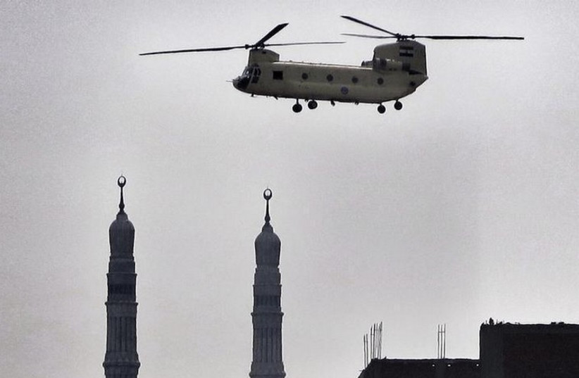 An army helicopter flies over a mosque in Cairo (photo credit: REUTERS)