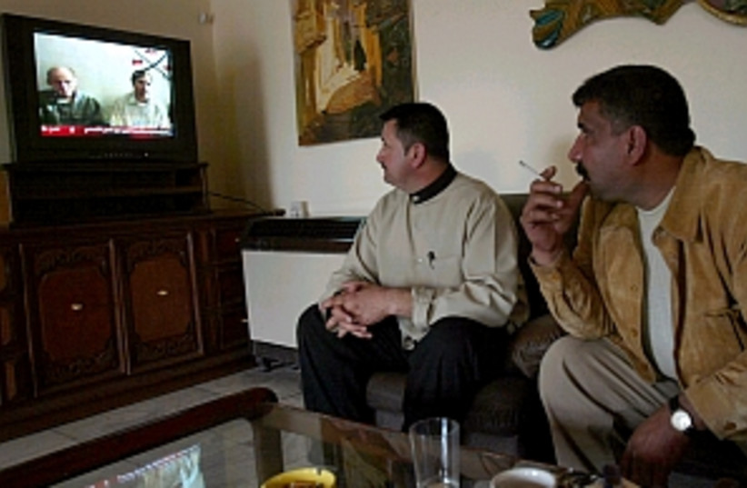 iraqis watch tv 298.88 (photo credit: AP)