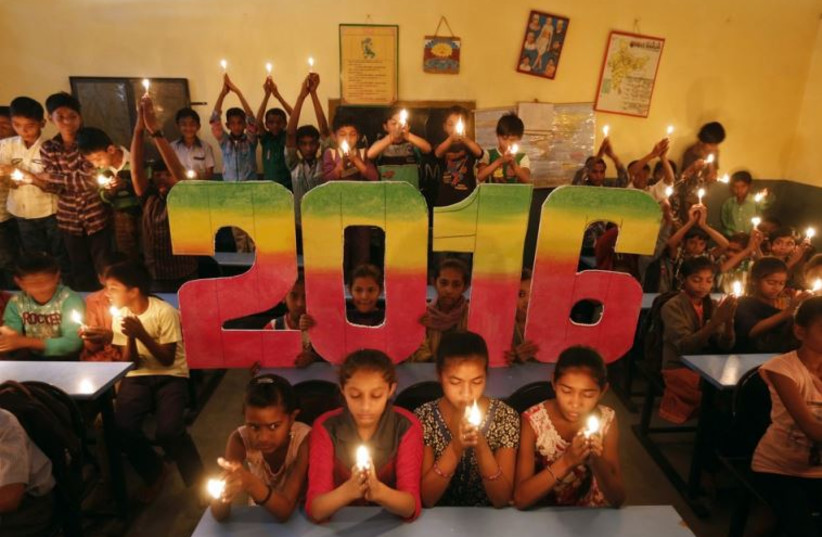 School students offer prayers for the world peace in the upcoming year of 2016 in Ahmedabad, India