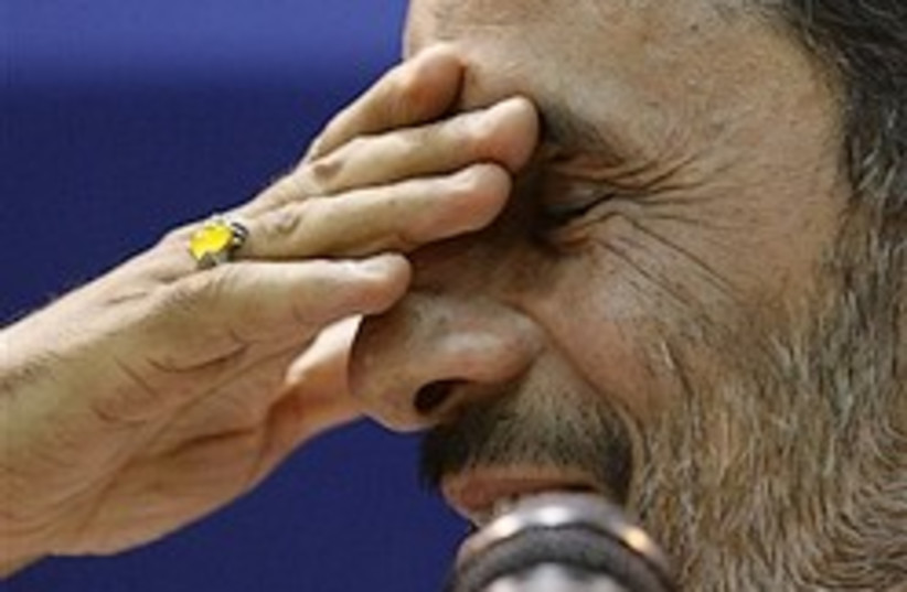 Ahmadinejad hand on eyes 248.88 (photo credit: AP)