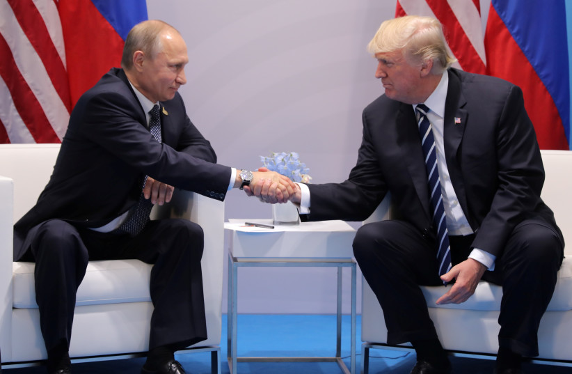 President Donald Trump shakes hands with Russia's President Vladimir Putin. (photo credit: REUTERS/CARLOS BARRIA)