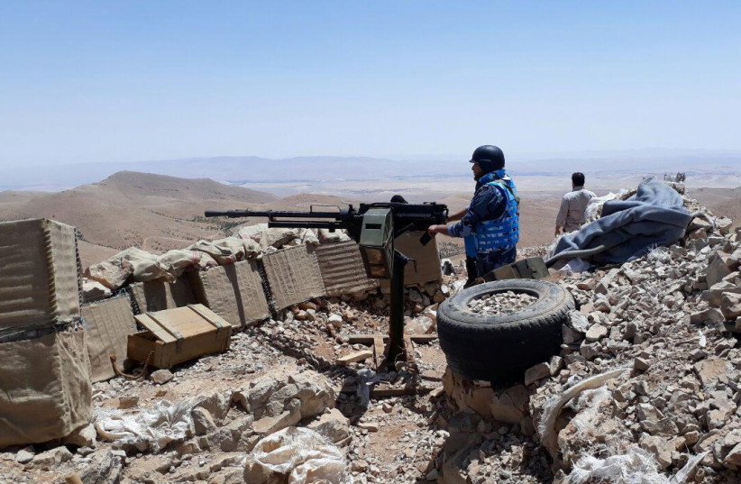 Fighters from the Syrian army units and Hezbollah are seen on the western mountains of Qalamoun, near Damascus, in this handout picture provided by SANA (photo credit: SANA/REUTERS)