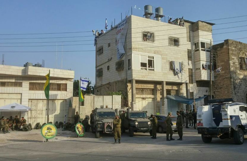 IDF soldiers outside of Beit Hamachpela building in Hebron.  (photo credit: ENLARGE THE PLACE OF THY TENT)