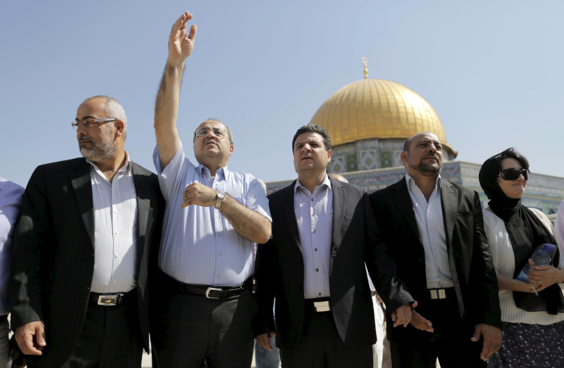 Israeli Arab lawmakers from the Joint Arab List (from L to R) Osama Saadi, Ahmed Tibi, Ayman Odeh, Masud Ganaim and Haneen Zoabi stand in front of the Dome of the Rock during a visit to the Temple Mount in Jerusalem's Old City July 28, 2015.  (photo credit: REUTERS)