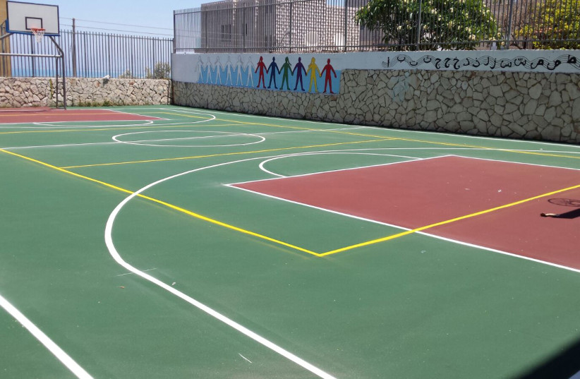 New basketball court at a Haifa school, July 2017. (photo credit: REUVEN COHEN/ HAIFA MUNICIPALITY)