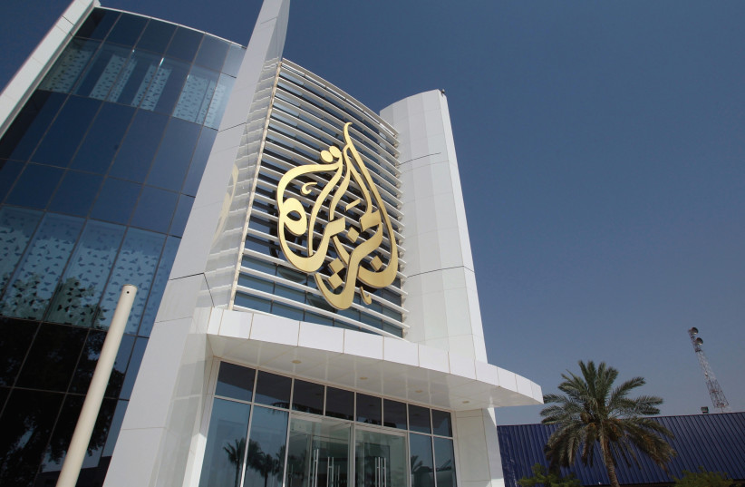 The Al-Jazeera Media Network logo is seen on its headquarters building in Doha, Qatar. (photo credit: REUTERS)