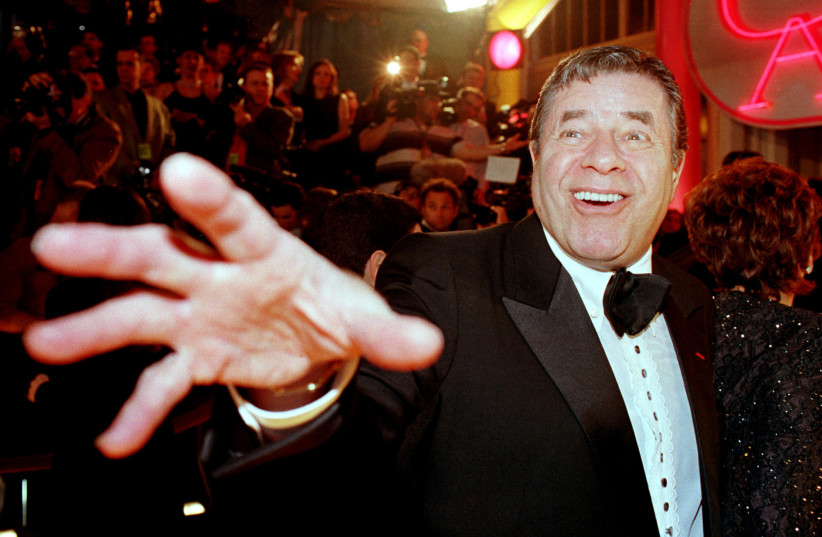 Comedian Jerry Lewis reaches out to cover the camera lens as he arrives at the 12th annual American Comedy Awards. (photo credit: REUTERS)