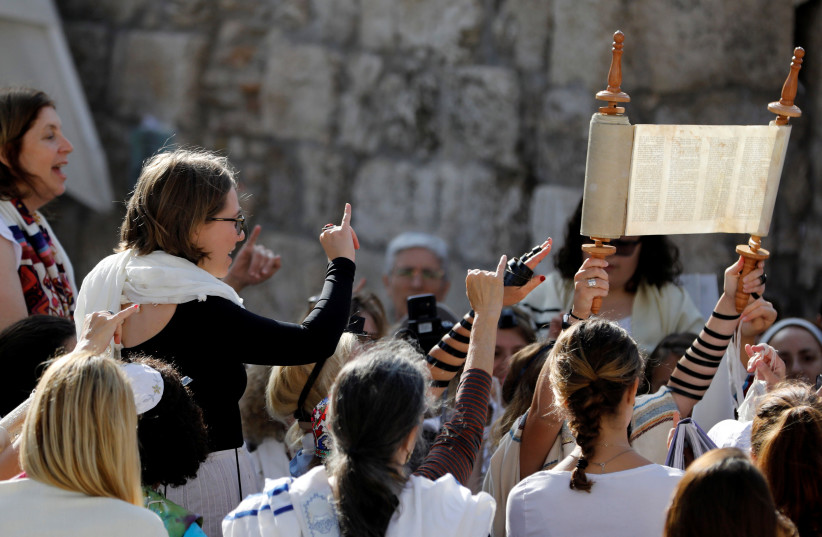 Members of "Women of the Wall" pray with a Torah scroll during a monthly prayer near the Western Wall in Jerusalem's Old City July 24, 2017 (photo credit: REUTERS/Ronen Zvulun)