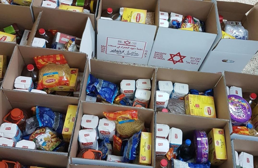 MDS Volunteers pack boxes of food ahead of Eid al-Adha, Summer 2017.. (photo credit: MDA)